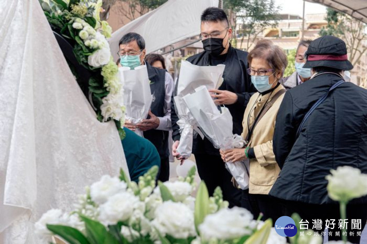 與會人員在紀念碑前獻花，表達對受難者的追思。