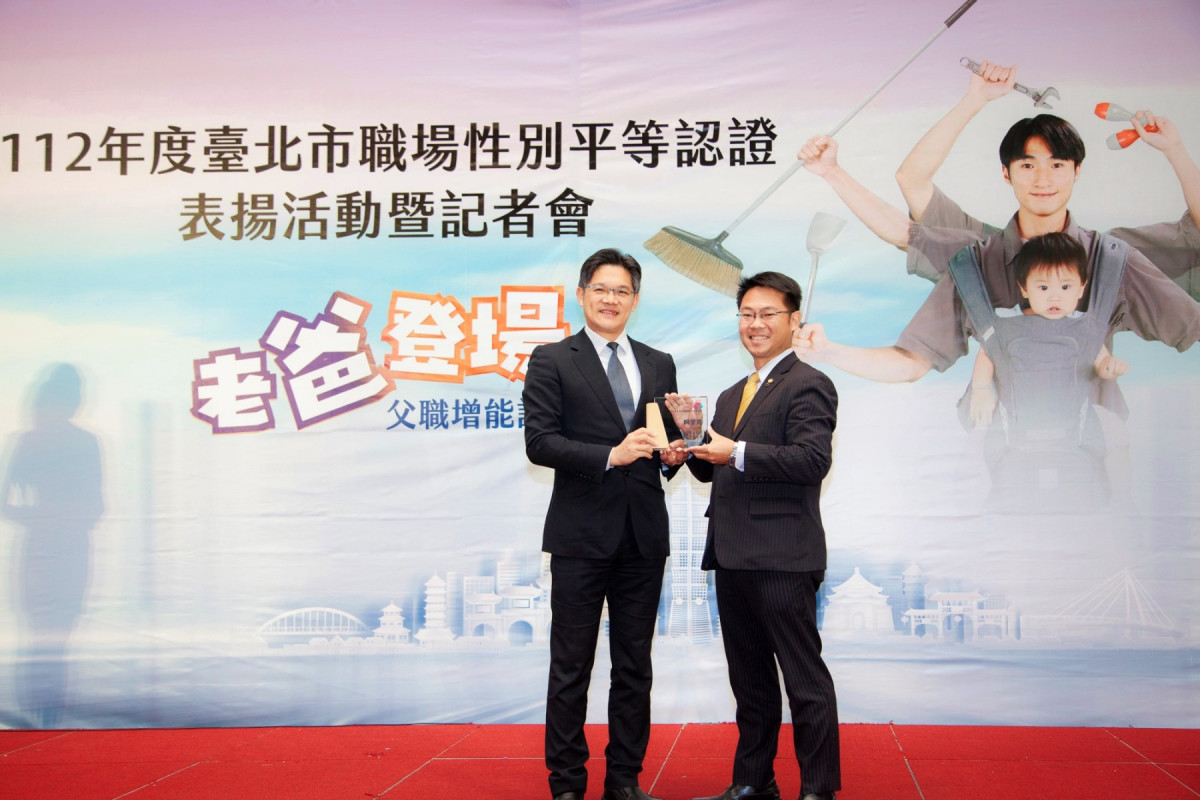 永慶房屋副總經理黃俊傑(右)從台北市副秘書長游適銘(左)手中接過2023年台北市職場性別平等認證銅質獎榮譽。