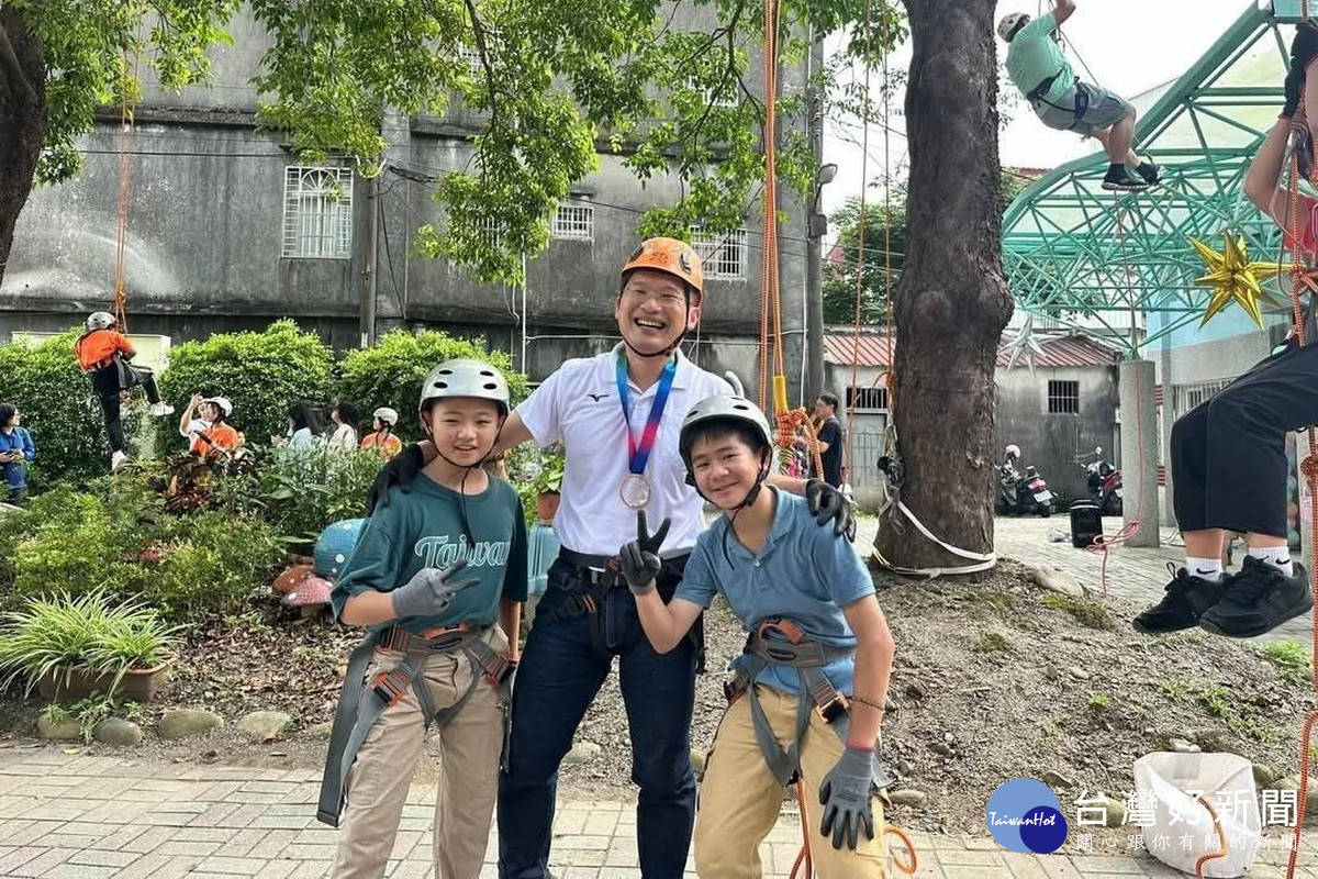 桃園市副市長蘇俊賓與攀爬茄苳樹同組的尤晨恩、丁麒同學合影。<br />
