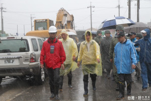 台南市長賴清德（中）颱風天在七股區長莊名豪（右）陪同下，冒雨視察龍山漁港聚落防護工程。（記者邱仁武／攝）