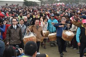 來賓擔飯擔走進會場。（記者郭春輝拍攝）