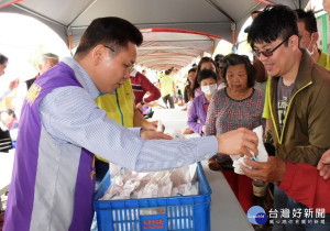 彰化優鮮雞推廣活動中，副縣長黃榮章親自服務民眾免費品嘗炸雞腿。