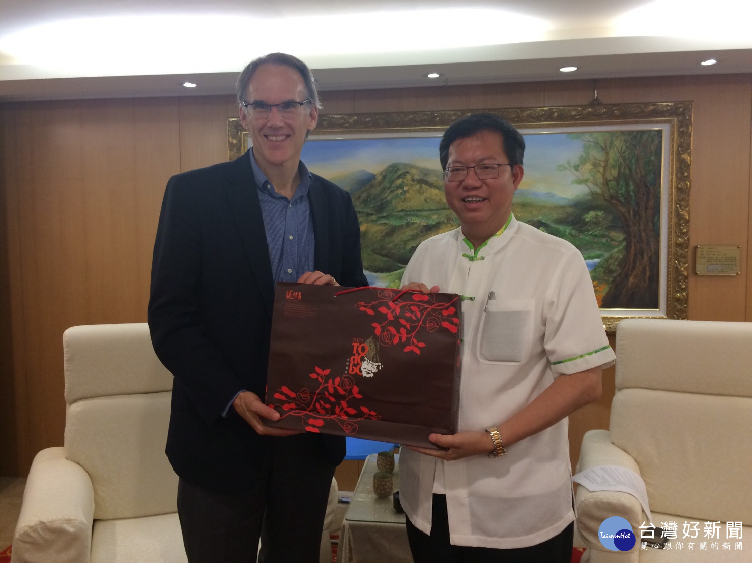 鄭文燦市長致贈台灣藍鵲瓷盤、土產花生糖予美國職棒大聯盟國際副總裁Jim Small。