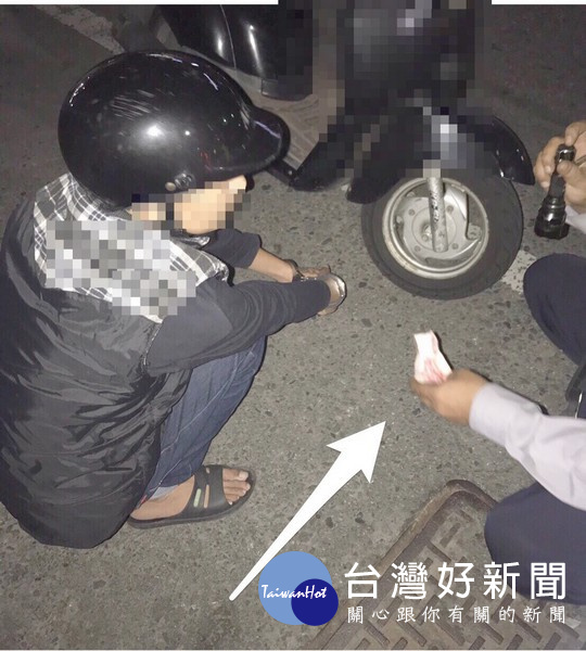 警方運用執法技巧,請男子配合自口袋內翻出包裹二級毒品安非他命的百元紙鈔。(記者陳昭宗拍攝)