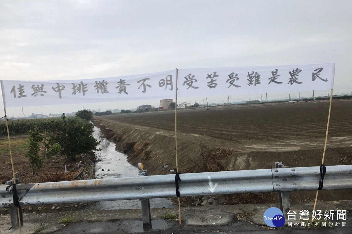 農民和住家掛白布旗抗議,公關門的權責不分,互踢皮球,導致佳里區佳興中排常一遇就淹水,民不聊生。(圖/記者黃芳祿攝)
