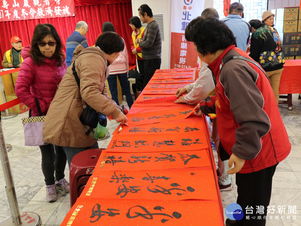 壽山巖觀音寺寒冬送暖活動中請來書法大師現場揮毫寫春聯，吸引許多民眾前來索取。