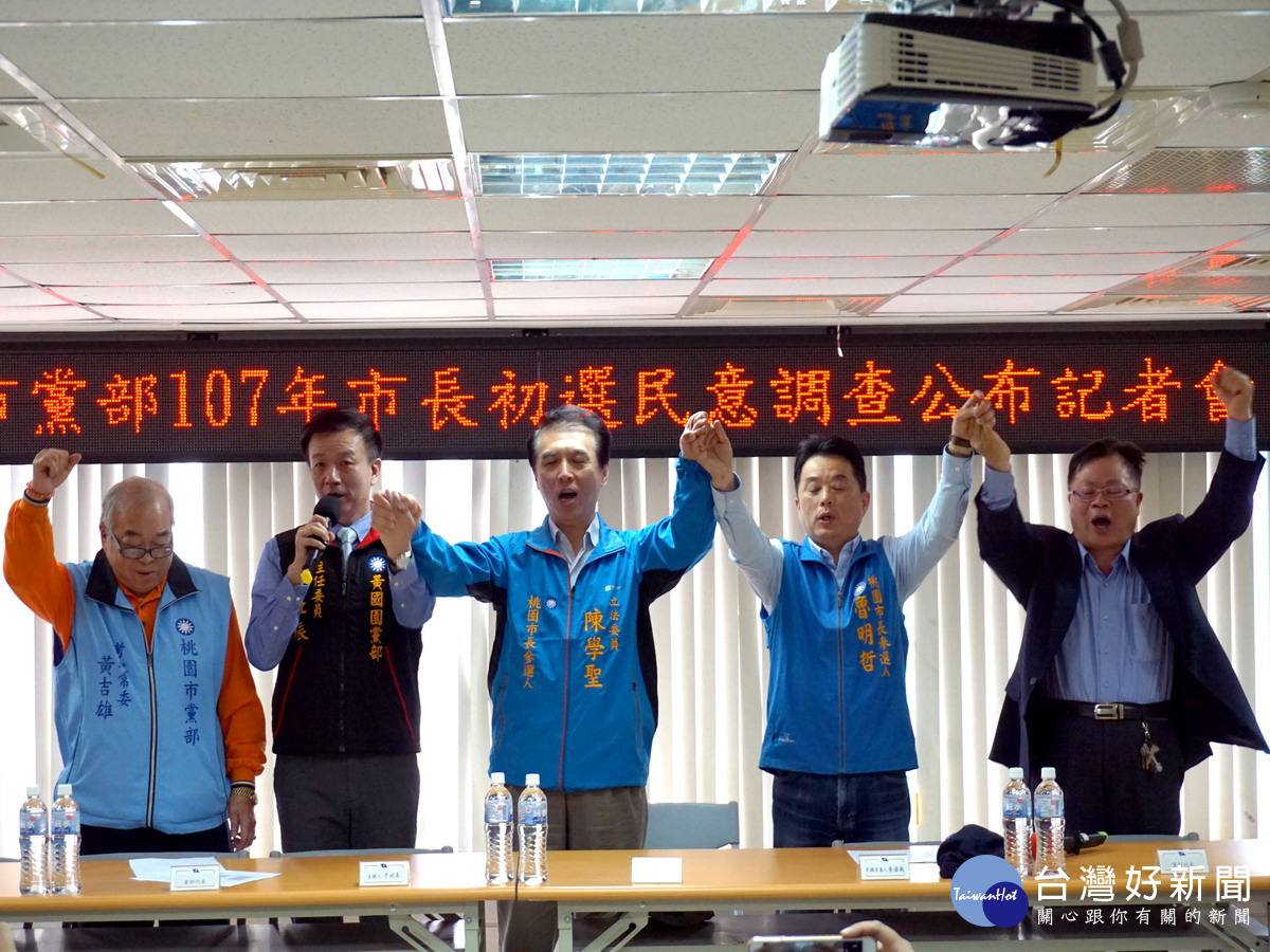 立委陳學聖在國民黨桃園市長初選民調中勝出，與黨部人員及另一位參選人魯明哲一起高呼勝利、團結。