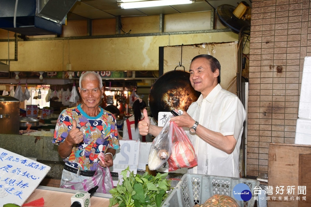 彰基副院長周志中醫師(右)前往菜攤買菜與關心呂老先生(左)健康狀況。