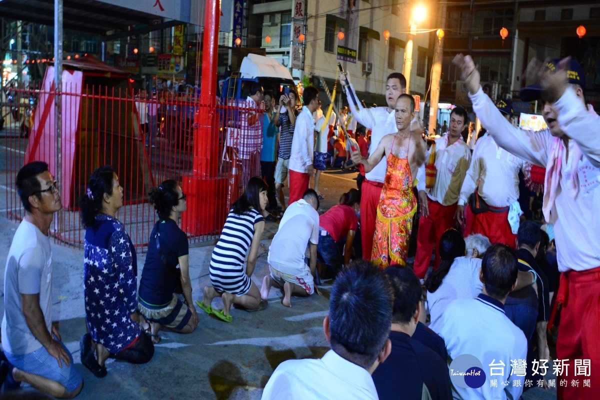 千歲爺「南巡」乩童行走途中,信徒沿途跪著等著被驅邪帶來好運,文武陣員舉起手勢叫信改好運的信眾平安起身。(圖/記者黃芳祿攝)