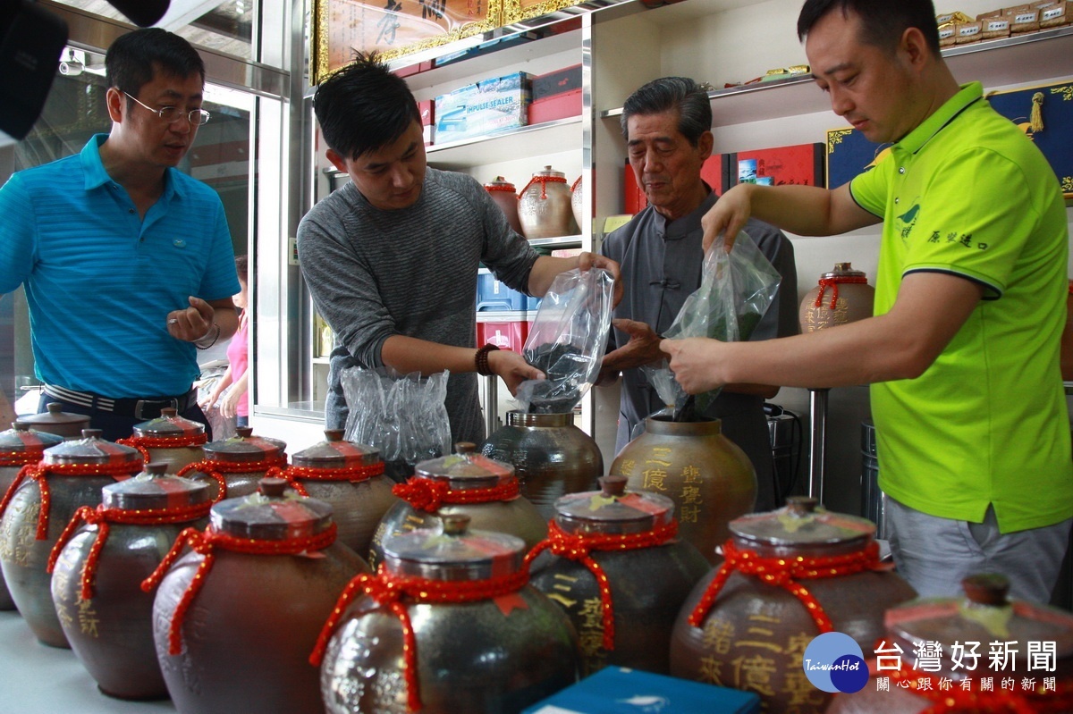 茶商親自體驗將老茶裝入生肖茶甕封籤。（記者扶小萍攝）