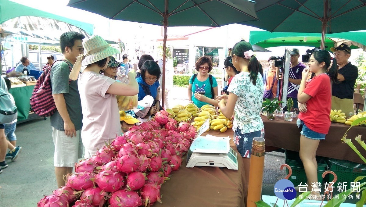 學生在集集農夫市集上義賣農特產品,遊客上門購買。