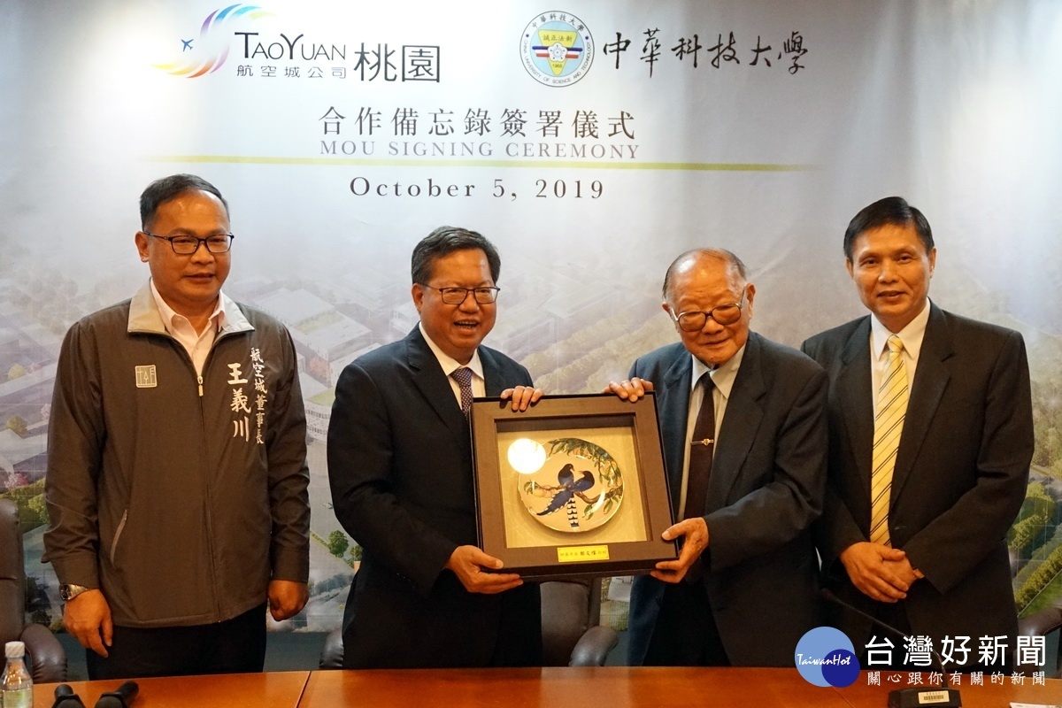 簽署儀式中，桃園市長鄭文燦回贈台灣藍鵲磁盤予孫永慶。