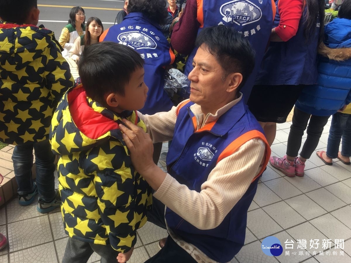 彰化扶幼委員細心為孩子扣上鈕釦。