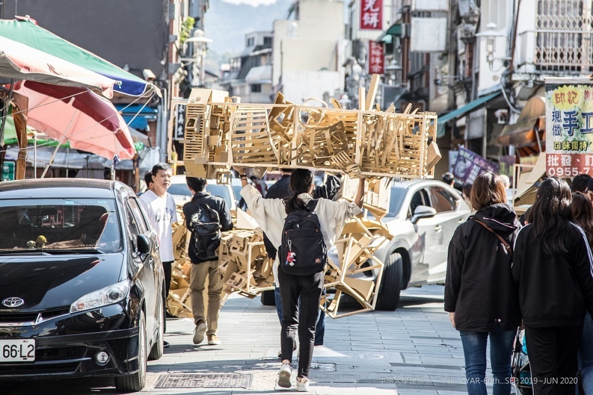 中原建築的學生頂著烈日，扛著作品往展區-福仁宮邁進