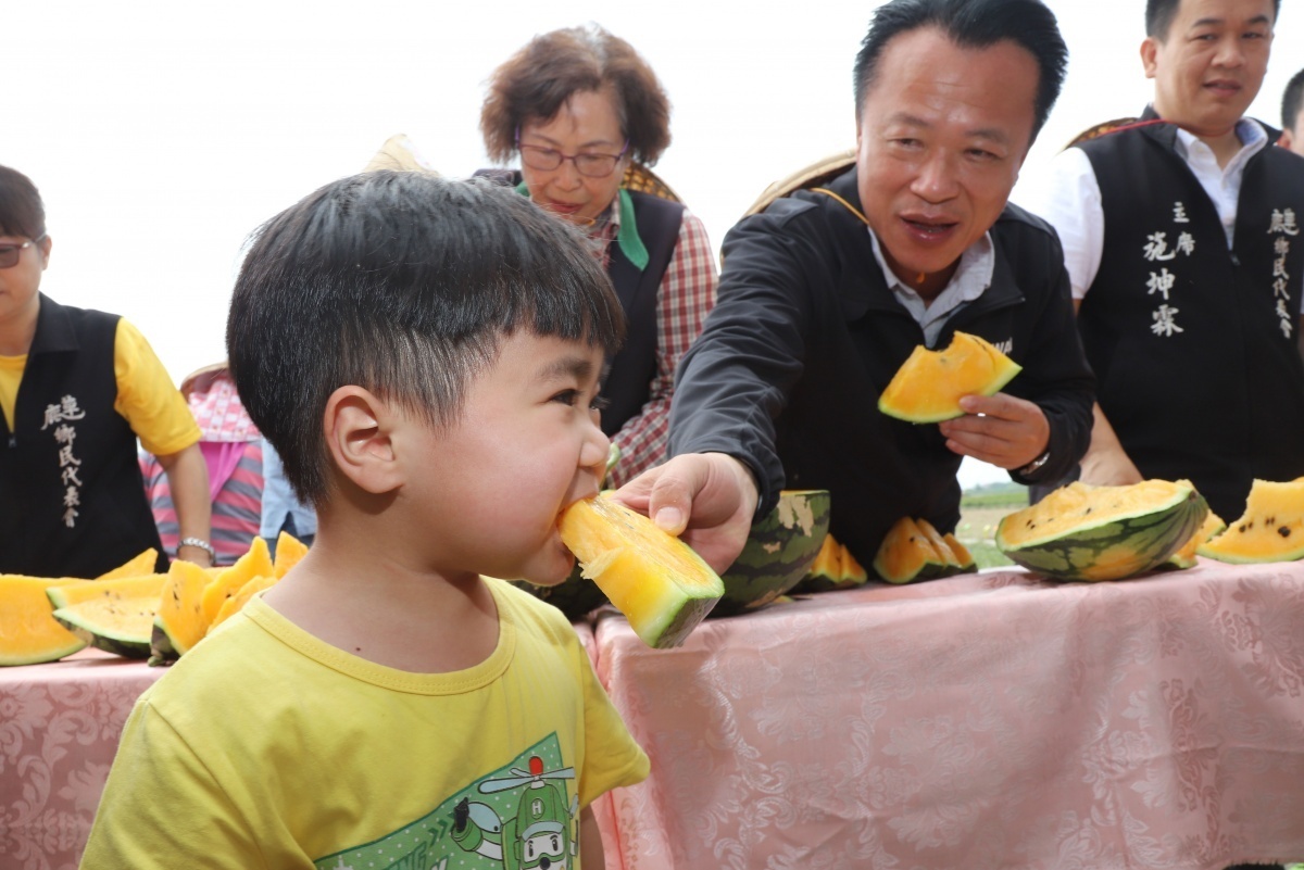 翁章梁將摘下的西瓜分切後遞給小男孩／陳致愷翻攝